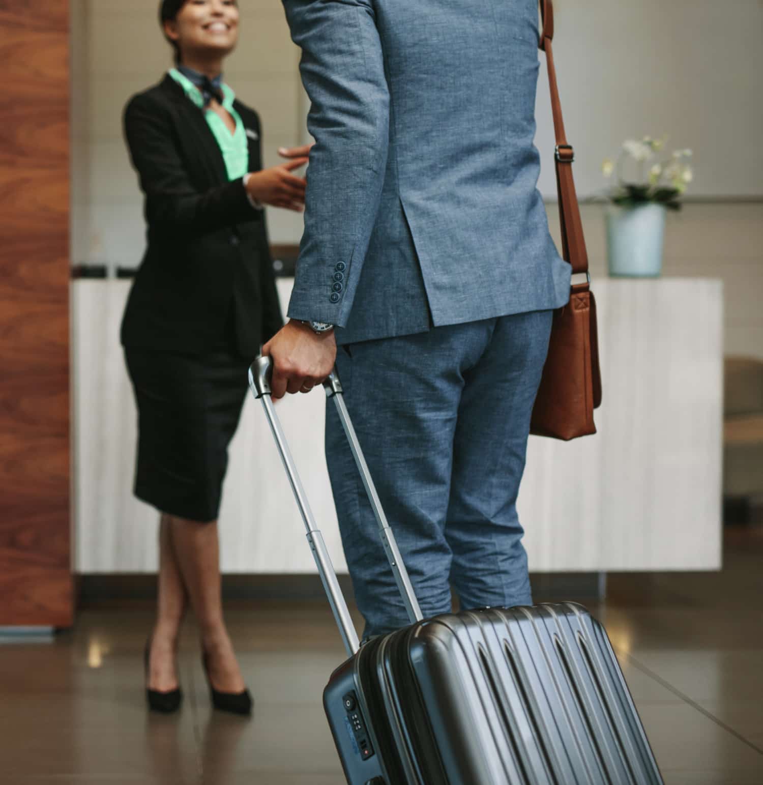 Hotel staff member greeting guest in the lobby